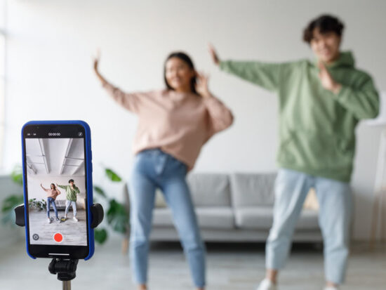 Millennial Asian Couple Dances and Vlogs at Home, Capturing Fun Moments on Smartphone